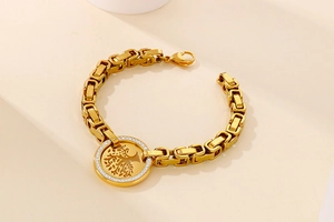 Detailed macro view of the golden tree of life charm with sparkling zircon inlay