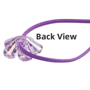 Macro view of the back connection structure of a purple iridescent flower hair tie