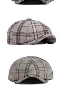 Detail of plaid newsboy cap showing grey check pattern and thick wool fabric texture