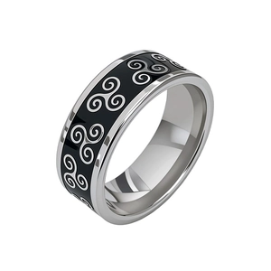 Macro detail of vintage titanium steel ring with black enamel and triskelion symbol