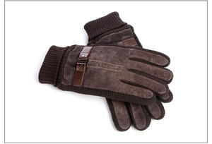 Detail of brown pigskin gloves featuring soft knit cuffs and premium leather strap accents