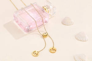 Detailed view of a gold heart-shaped toggle necklace with a family silhouette pendant