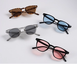 Detail of round small frame sunglasses with colorful lenses and rivet accents
