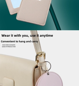 Close-up of litchi grain PU leather card holder with metal ring on a handbag