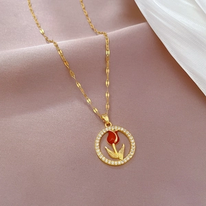 Luxurious gold tulip pendant necklace with micro-paved crystals on silk background