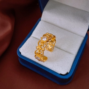 Close-up of a gold-plated square open ring with zircons in a blue jewelry gift box