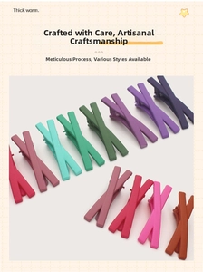 Detail of matte X-shaped candy colored hair clips set with smooth frosted texture