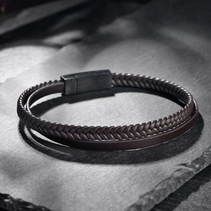Close-up of double-layer brown braided leather bracelet with magnetic steel clasp