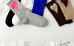 Flat lay of colorful cotton crew socks featuring contrast heart embroidery in various shades