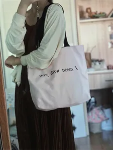 Pink canvas tote bag with black strap featuring I mean with you lettering detail