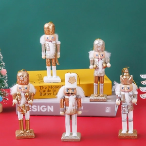 Detail of five gold and white wooden glitter nutcracker soldiers on festive display