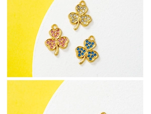Macro shot of gold four-leaf clover charms with white pink and blue rhinestones