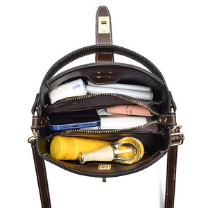 Dark brown leather bucket bag with spacious multi-compartment interior for daily essentials