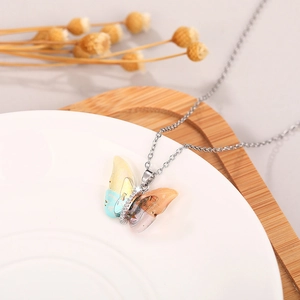 Close-up of a colorful gradient acrylic butterfly pendant with S925 silver stamp and crystals