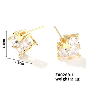 Macro shot of gold square stud earrings with zircons and size markings 1.1cm x 1.3cm