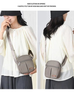 Dual-view of a gray nylon crossbody bag with adjustable wide branded shoulder strap