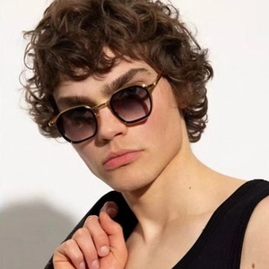 Detail of vintage square metal sunglasses with gold frame and purple gradient lenses