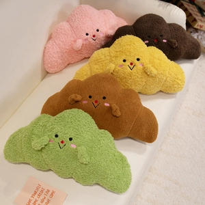 Soft teddy fleece cartoon croissant plush pillows in various colors on a white sofa