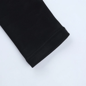 Close-up of double-stitched cuff on black knitted sweatshirt showing premium sewing detail