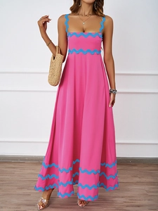 Detail showing the bright pink maxi dress with blue scalloped edges and spaghetti straps