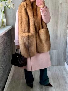 Brown faux fur shawl with integrated pockets shown over a pink coat for winter fashion
