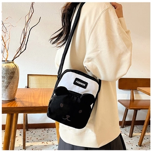Close-up of contrast cartoon crossbody bag with cute panda face and fashion label