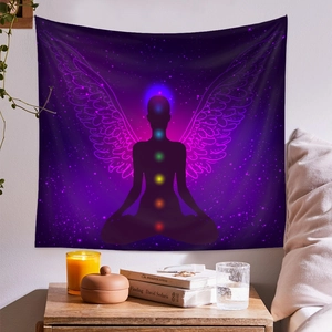 Detail of a purple meditation tapestry featuring chakras and starry sky in a cozy room setting