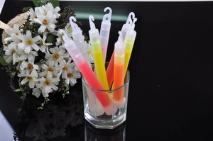 Colorful 6-inch plastic glow sticks with hook design placed in a clear glass vase