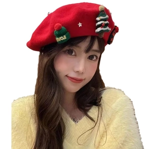 Red wool Christmas beret with knitted tree and star details worn by a model