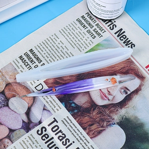 Macro view of slender translucent silicone ballpoint pen mold with a purple resin pen