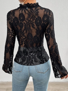 Detail of the high-neck back design and intricate lace pattern on a black long sleeve top