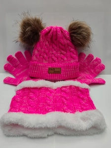 Detail of neon pink winter knit set with thick faux fur lining and plush pom-poms