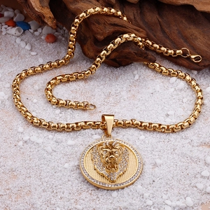 Detail of gold lion head pendant with sparkling rhinestones on box chain necklace