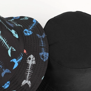 Reversible bucket hat with fish bone print and minimalist plain black design in cotton