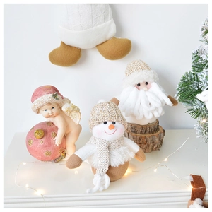 Detailed view of Christmas plush snowmen and angel figurines with festive LED lights