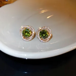 Elegant gold flower earrings with olive green zircon and shimmering crystal halo