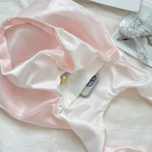 Detailed interior of the pink and white satin tote bag featuring a secure zipper pocket