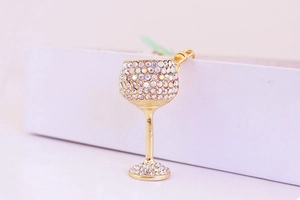Close-up of elegant gold wine glass keychain with AB crystals and spring buckle
