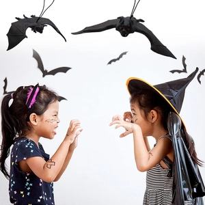 Realistic black rubber bats hanging on a wall for Halloween party atmosphere decorations