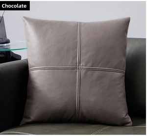 Detail of chocolate faux leather pillow cover featuring cross-stitch sewing patterns