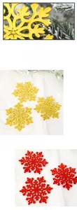 Detail view of decorative gold and red snowflake ornaments with metallic finish texture