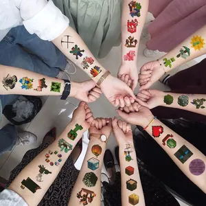 Detail shot of various Minecraft pixel art tattoo designs applied on arms of children