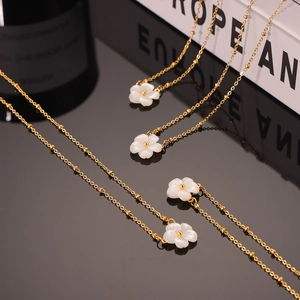 Elegant 18K gold plated titanium necklace with white shell flower pendant on black base