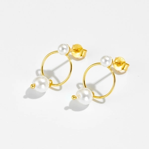 Detailed view of S925 sterling silver gold-plated pearl hoop earrings on white background
