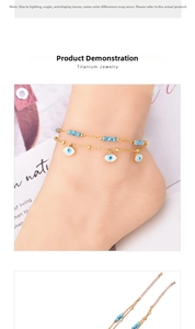 Detail of double-layer titanium anklet with turquoise beads and blue evil eye charms