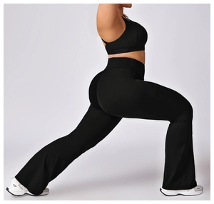 Detailed side view of high-waist flared yoga pants and racerback sports bra in black