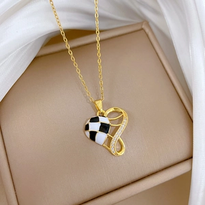 Macro detail of houndstooth heart necklace with gold plating and sparkling crystals