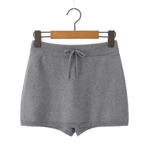Detail of dark grey knit mini skirt with elastic drawstring waist on a wooden hanger