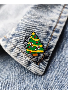 Macro view of a colorful Christmas tree enamel brooch pinned on a denim jacket collar