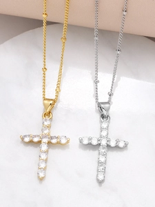 Detailed close-up of gold and silver cross necklaces with sparkling zircon stones